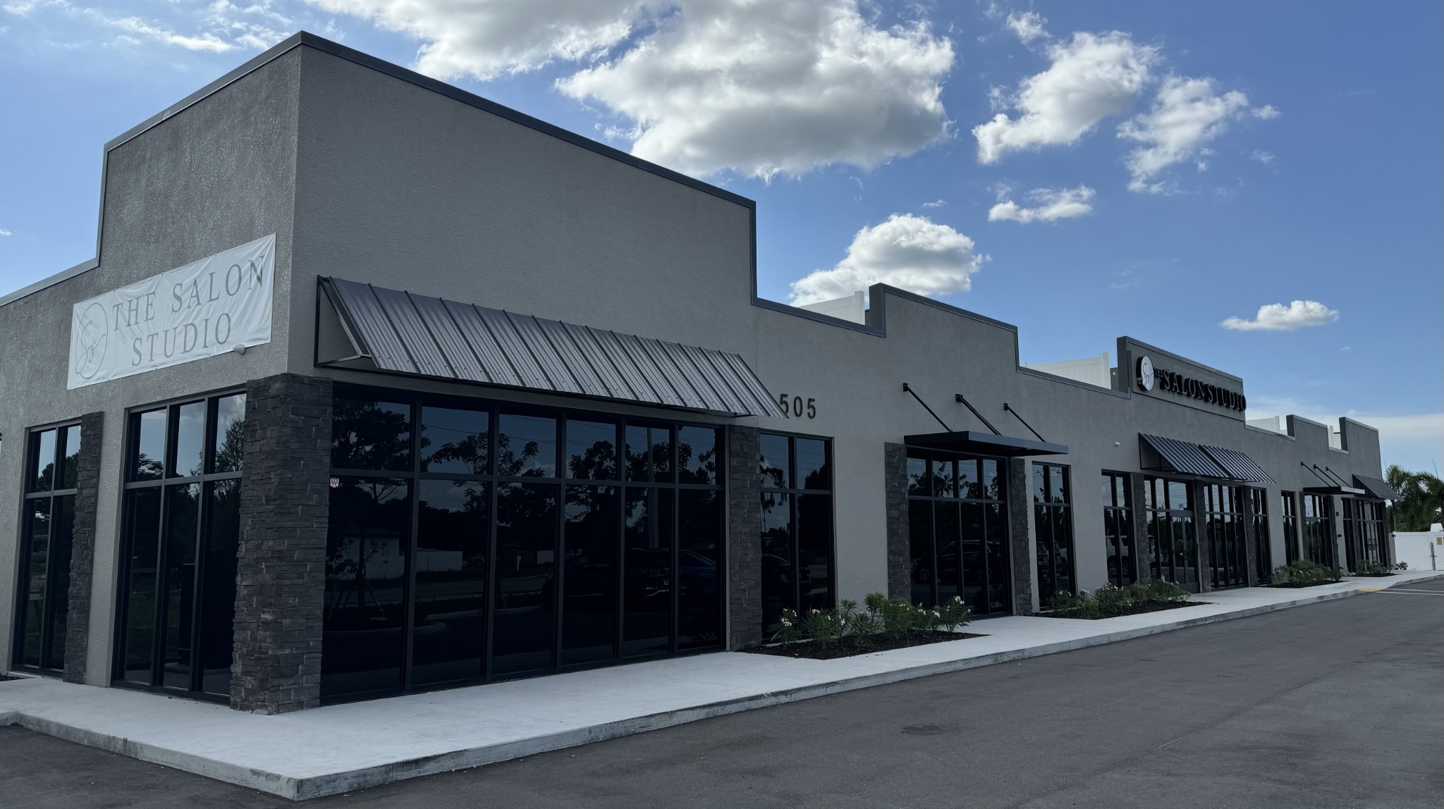 Actual exterior of Varsity Crossing at 505 Gunnery Road, including The Salon Studio storefront